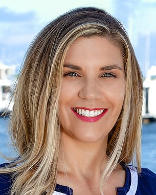 Alyssa Freeman, Chair Elect, professional headshot outdoors with marina and boats in the background.