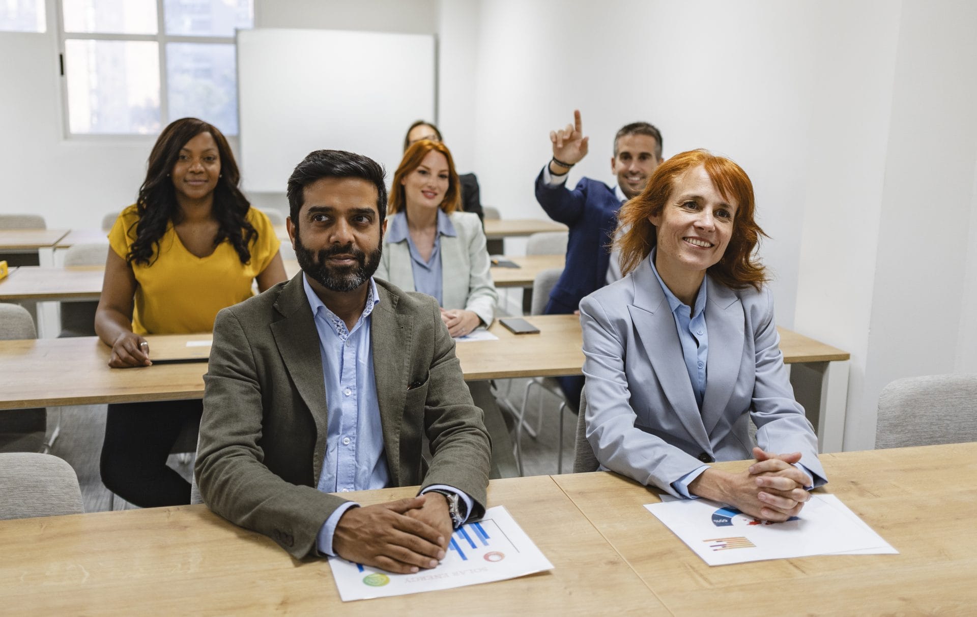 Diverse group of professionals seated in a classroom during a training session.