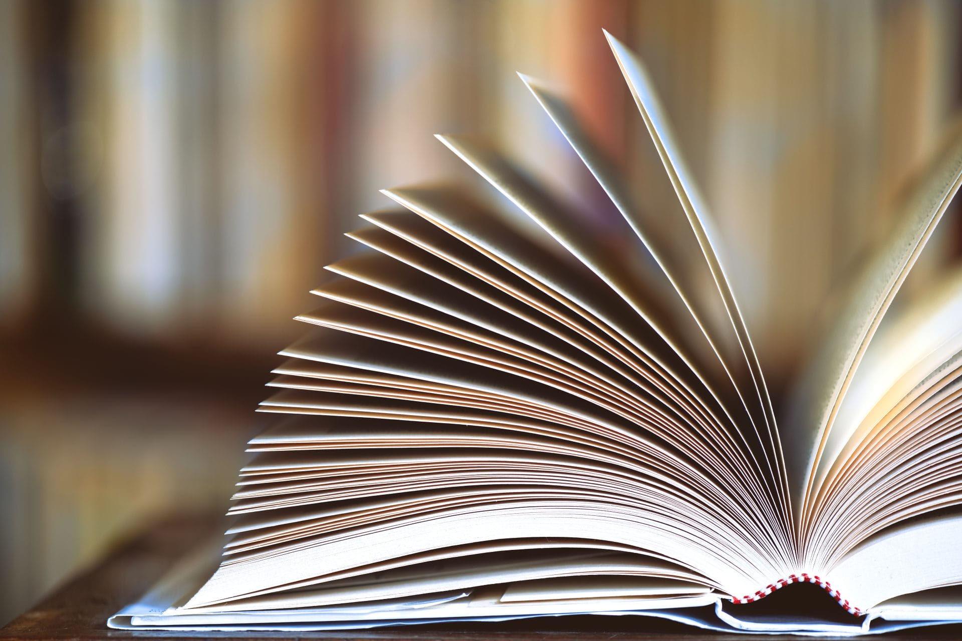 Open book with fanned pages, representing transparency, access, and shared information.