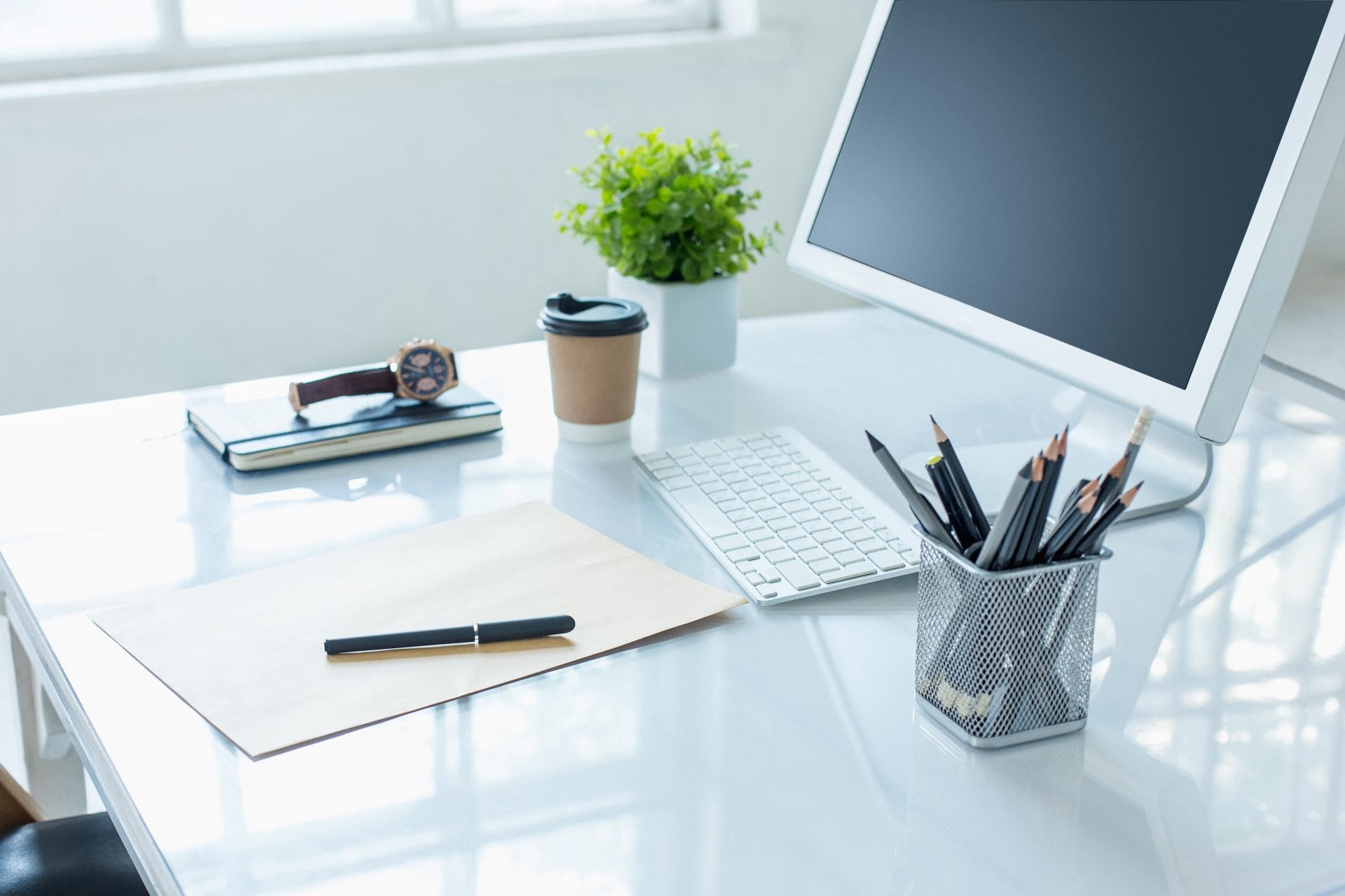 Bright modern workspace with a laptop, coffee cup, and office supplies on a desk, symbolizing professional growth and productivity.