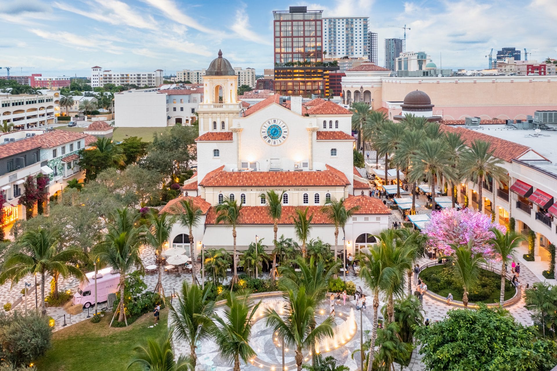 Aerial view of downtown West Palm Beach with colorful buildings and palm trees, symbolizing community and regional partnership.